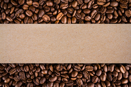 Roasted coffee beans background with brown paper box or Corrugated cardboard for product labelの写真素材