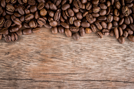 Coffee beans on old wood backgroundの写真素材
