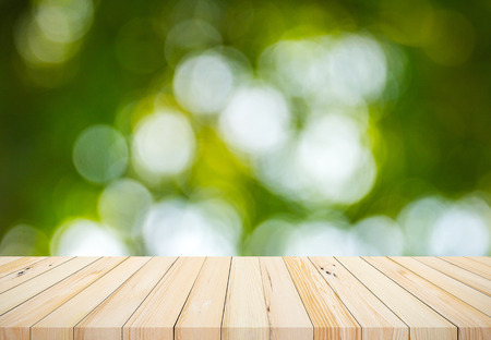 Wood plank with abstract natural green blurred bokeh background for product displayの写真素材