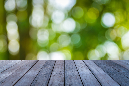 Old wood plank with abstract natural green blurred bokeh background for product displayの写真素材