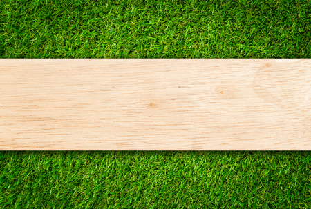 Wood plank on Grass backgroundの写真素材
