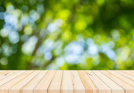 Old wood plank with abstract natural green blurred bokeh background for product displayの写真素材