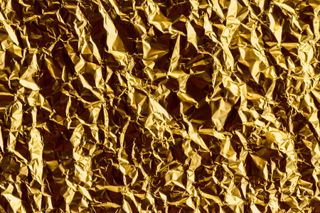 Crumpled gold foil texture backgroundの写真素材