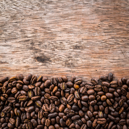 Flame with Coffee beans on old wood backgroundの写真素材