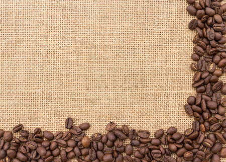 Frame with coffee beans on burlap backgroundの写真素材