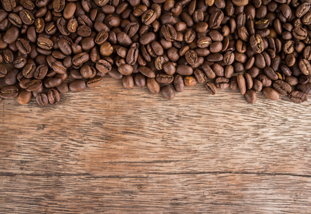 Coffee beans on old wood backgroundの写真素材