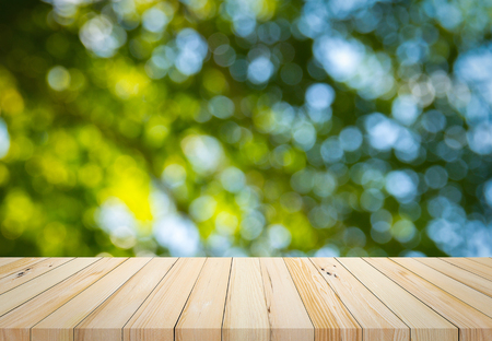 Old wood plank with abstract natural green blurred bokeh background for product displayの写真素材