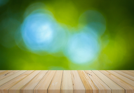 Old wood plank with abstract natural green blurred bokeh background for product displayの写真素材