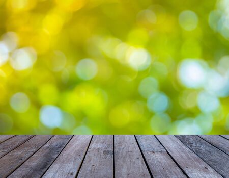 Old wood plank with abstract natural green blurred bokeh background for product displayの写真素材