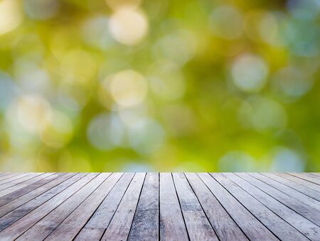 Old wood plank with abstract natural green blurred bokeh background for product displayの写真素材