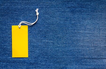 Emtry Yellow price tag on blue jaens texture backgroundの写真素材