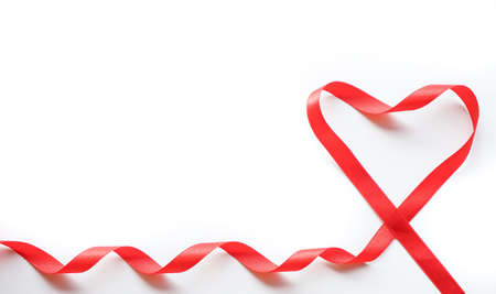 Red ribbon with heart shape on white background. Valentines day Or Love background concept.の写真素材