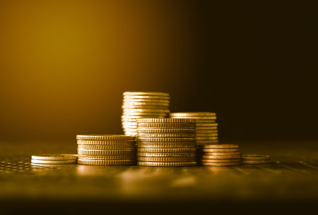 stacks of gold money coin on black background, Business and Saving money concept.