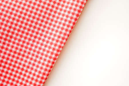 Pink plaid fabric or tablecloth on white background with copy space.