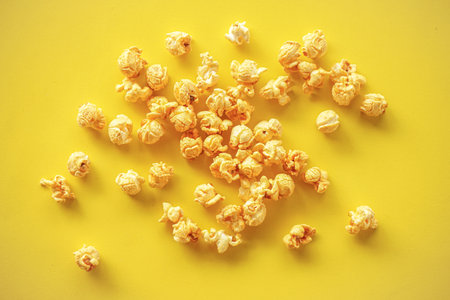 Popcorn on yellow paper backgroundの写真素材
