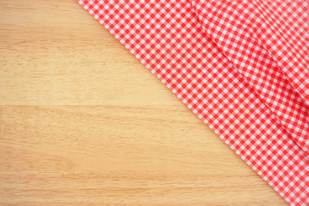 Classic pink plaid fabric or tablecloth on wood desk with copy spaceの写真素材