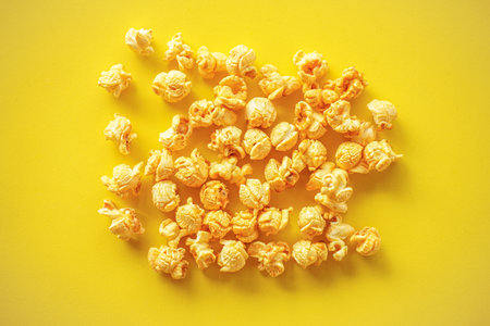 Popcorn on yellow paper backgroundの写真素材