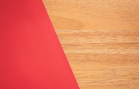 Red paper on wood table can be use as backgroundの写真素材