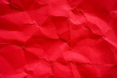 Red crumpled paper texture backgroundの写真素材