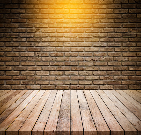 Old wood table with abstract old brick wall with light background for product displayの写真素材