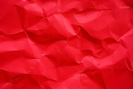 Red crumpled paper texture backgroundの写真素材