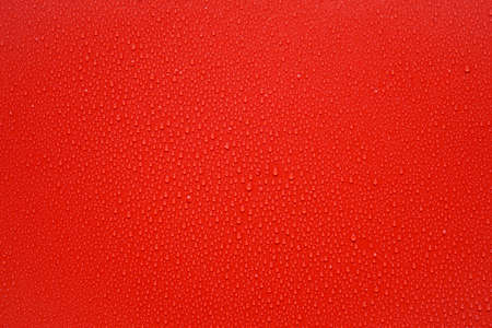 Water drops on red backgroundの写真素材