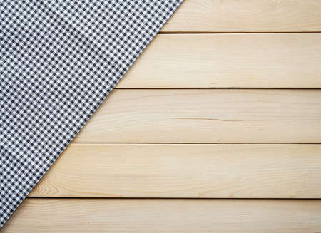 Classic black plaid fabric or table cloth on wood plank with copy spaceの写真素材