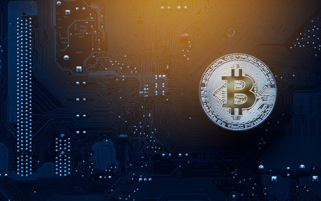 Gold bitcoin on computer mainboard with trading graph, Mining and trade bitcoin concept.の写真素材