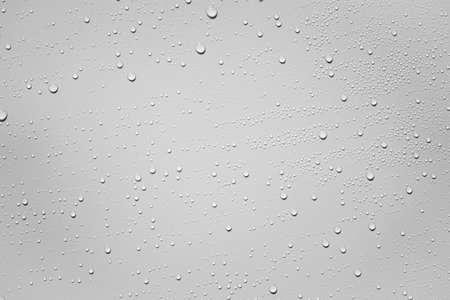 Water or rain drops on white plastic sheet backgroundの写真素材