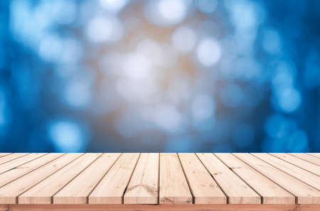 Wood table or wood floor with abstract blue bokeh background for product displayの写真素材