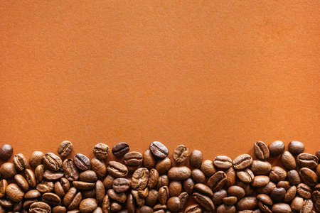 Roasted coffee beans on brown paper backgroundの写真素材