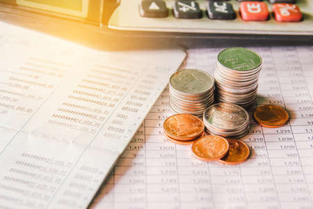 money coin on accounting report sheet background, Saving money or finacial concept.の写真素材
