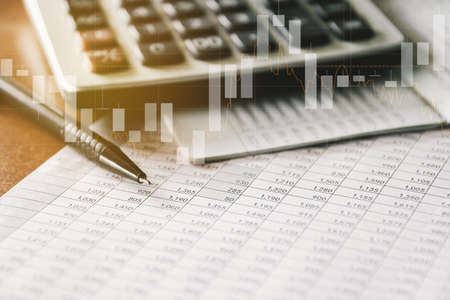 Pen and Calculator on accounting report with trading graph, Business and Financial concept.の写真素材