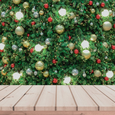 Wood table top on blur christmas tree background - can be used for display or montage your products