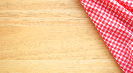Red checkered tablecloth on wooden background. Top view with copy spaceの写真素材