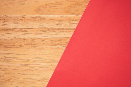 Red and brown paper on wooden table background. Top view with copy spaceの写真素材