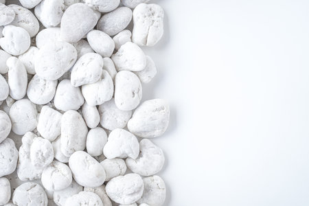White pebbles on white background with copy space for text.の写真素材