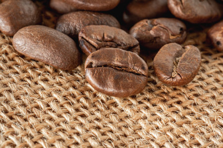 Coffee beans on sackcloth background. Close up of coffee beans.の写真素材