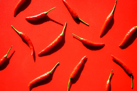 Red hot chili peppers on a red background. Flat lay, top viewの写真素材