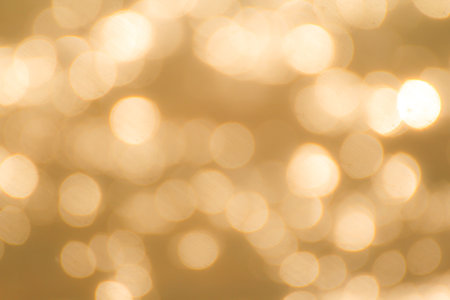 Gold bokeh abstract light background. Christmas and new year concept.の写真素材