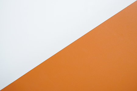 Orange and white paper background with copy space for text or image.の写真素材