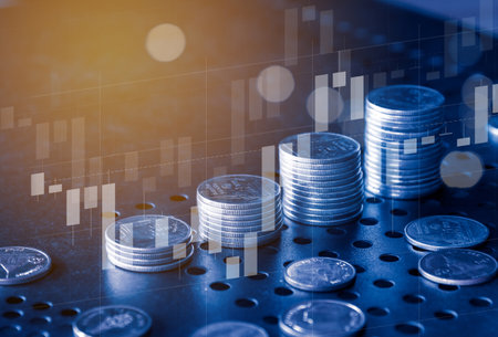 Double exposure of coin stack with stock market graph and LED light, business and finance concept idea.の写真素材