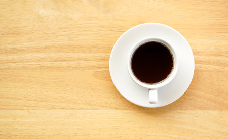 Coffee cup on wooden table, top view with copy spaceの写真素材