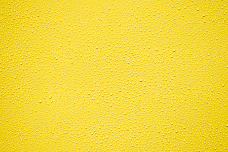 Water drops on yellow background. Water drops texture for design and decoration.の写真素材