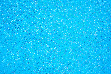 Water drops on blue background. Water drops on blue glass texture.の写真素材