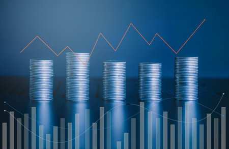 Stacks of coins with graph background, business and finance concept idea.の写真素材