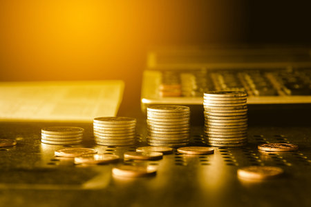 Coins stacked on each other in different positions and blur background.の写真素材