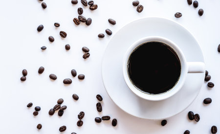 Coffee cup and coffee beans on white background, top viewの写真素材