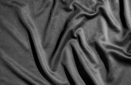 Texture, background, pattern. Black satin fabric. This is a photograph of a crumpled black satin fabricの写真素材
