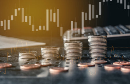Double exposure of coins stack and graph stock market or forex trading graph and candlestick chart suitable for financial investment concept.の写真素材